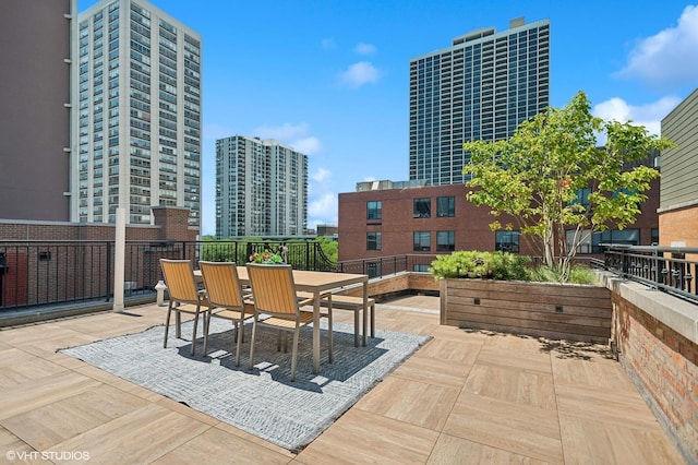 view of patio / terrace with outdoor dining area and a city view