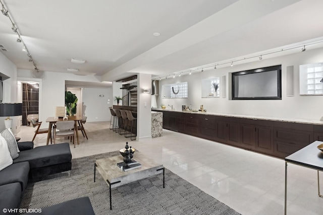 living room featuring track lighting and bar