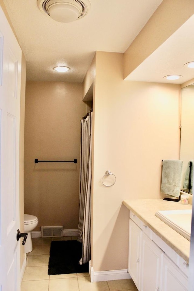 bathroom with visible vents, toilet, and tile patterned flooring