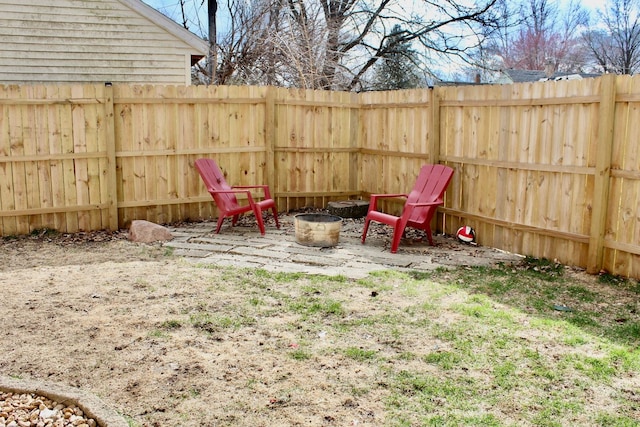 view of yard featuring a fire pit and fence