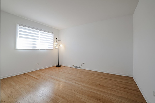 unfurnished room with visible vents, baseboards, and light wood-type flooring