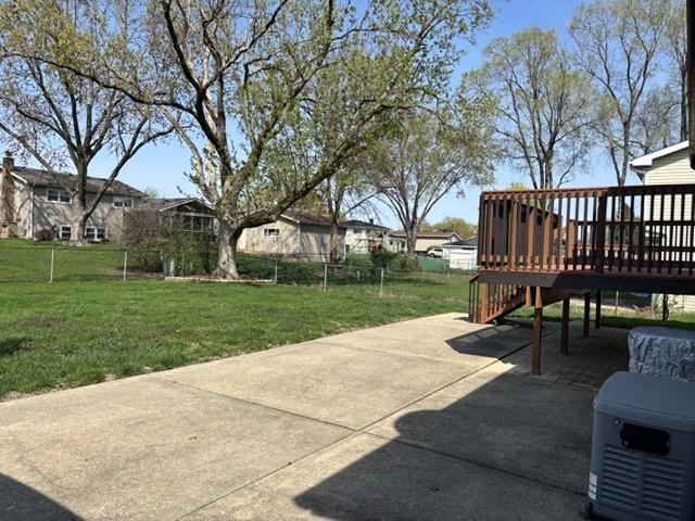 view of patio featuring a deck and fence