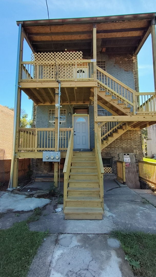 exterior space with brick siding and covered porch