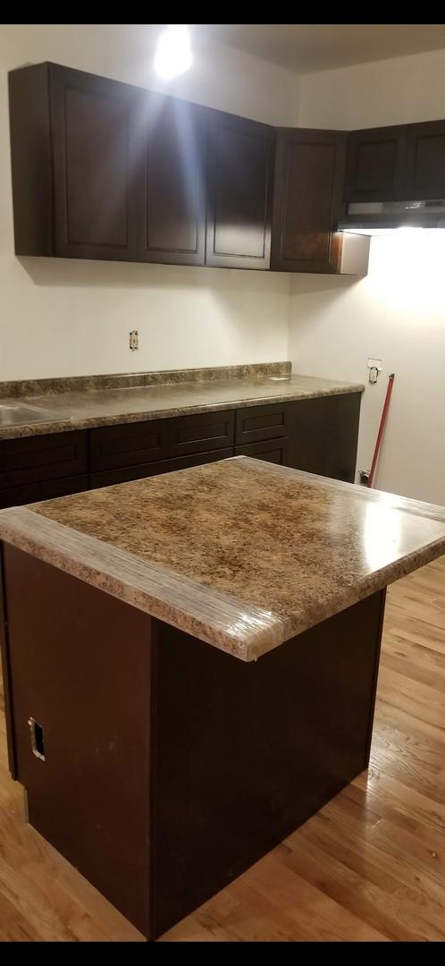 kitchen with light countertops and light wood-style flooring