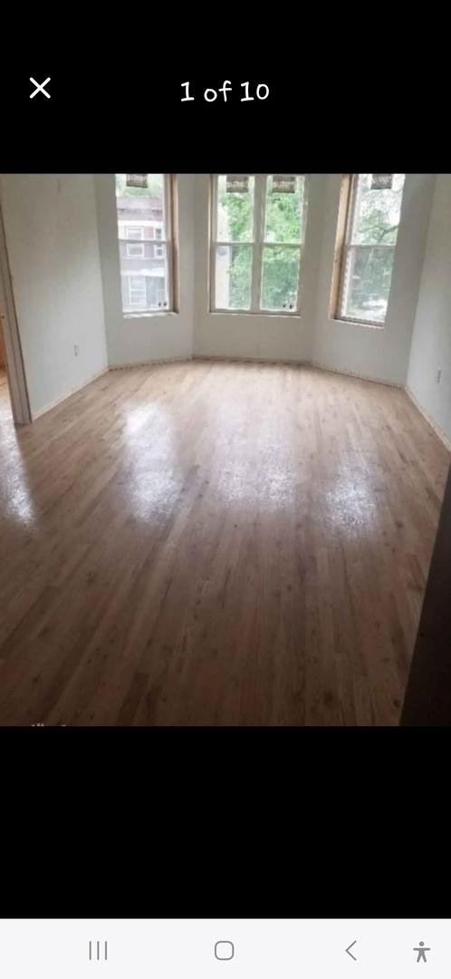 unfurnished room with wood finished floors and a healthy amount of sunlight