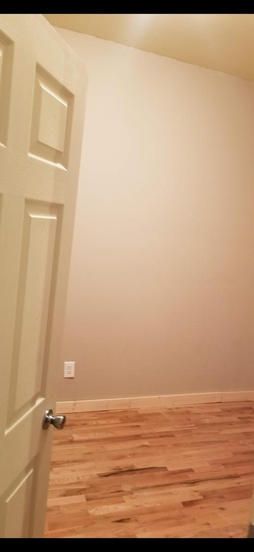 empty room featuring baseboards and wood finished floors