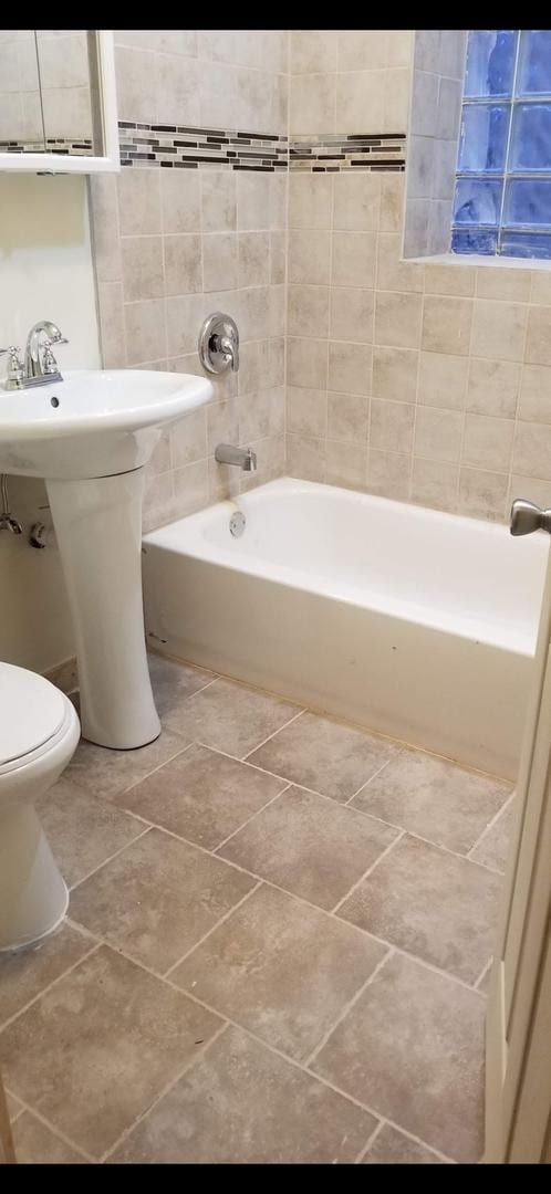 full bath with tile patterned floors, shower / bath combination, and toilet