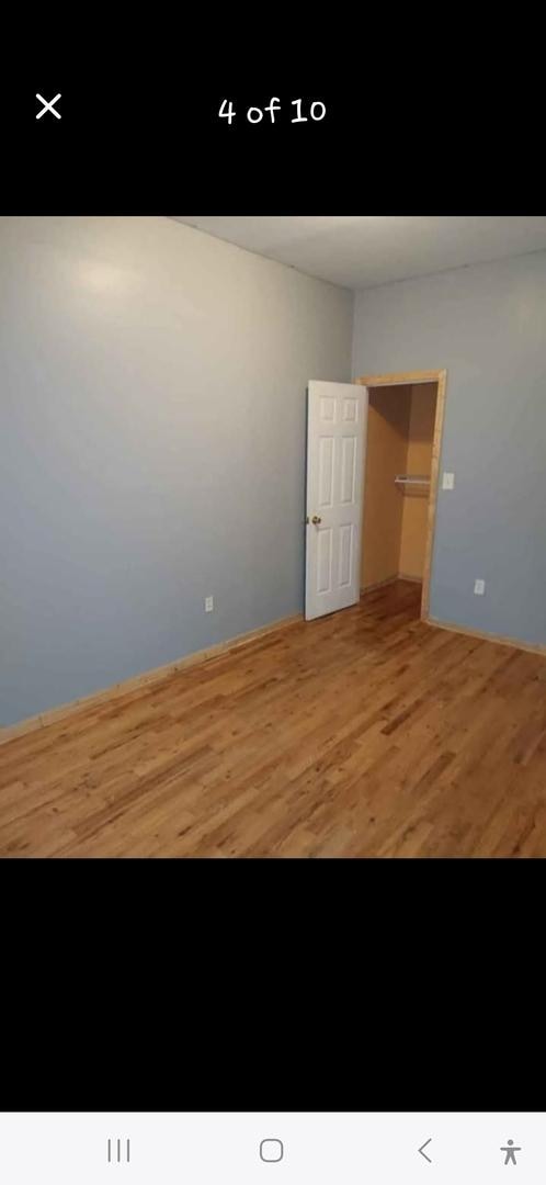 unfurnished room with wood finished floors