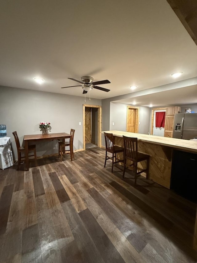 dining area featuring dark wood-type flooring and a ceiling fan