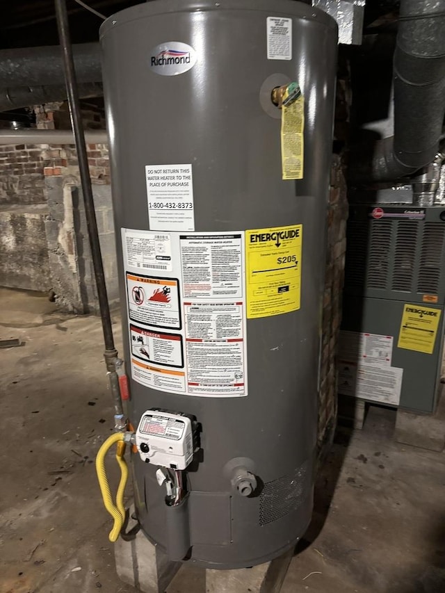 utility room with heating unit and gas water heater
