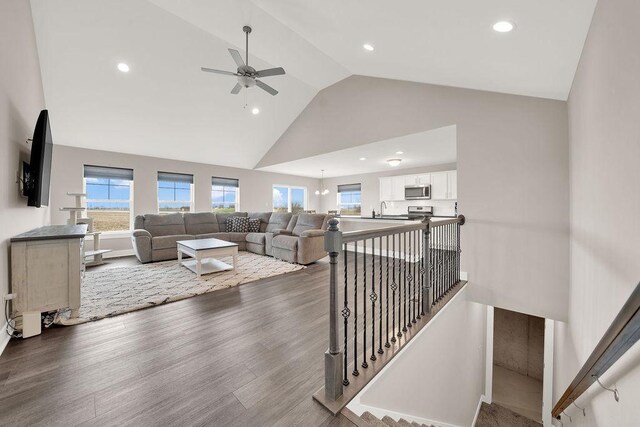 living area featuring high vaulted ceiling, wood finished floors, ceiling fan, and recessed lighting