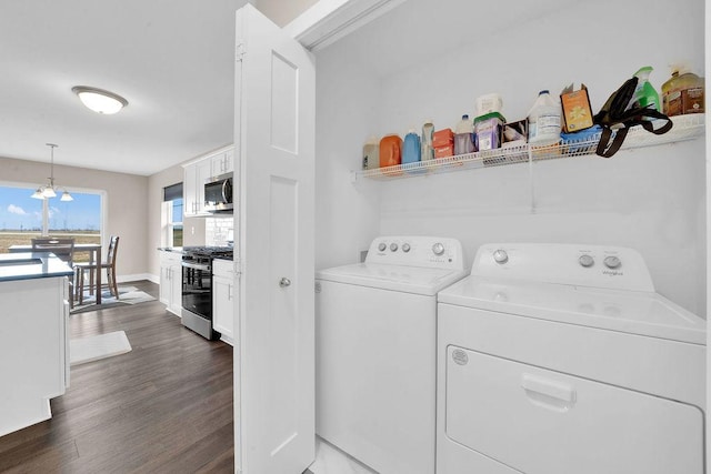 laundry area featuring laundry area, dark wood-style flooring, baseboards, and separate washer and dryer