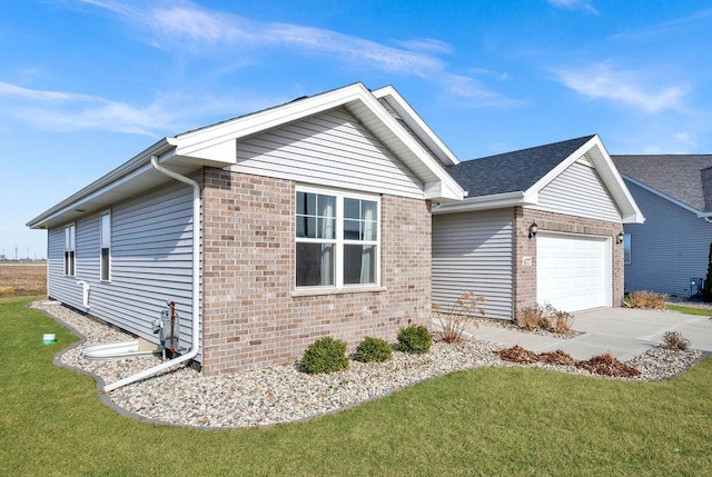 view of side of property with an attached garage, brick siding, a lawn, and concrete driveway