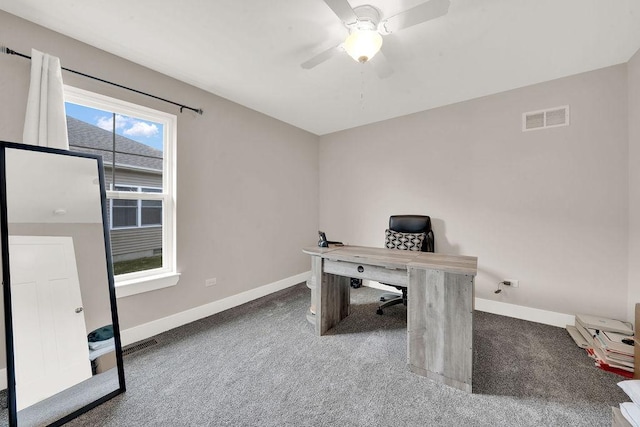 carpeted office space with baseboards, ceiling fan, and visible vents