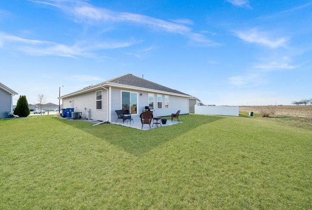 back of house featuring fence, cooling unit, a patio area, and a yard