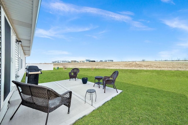 view of patio / terrace featuring area for grilling and a rural view