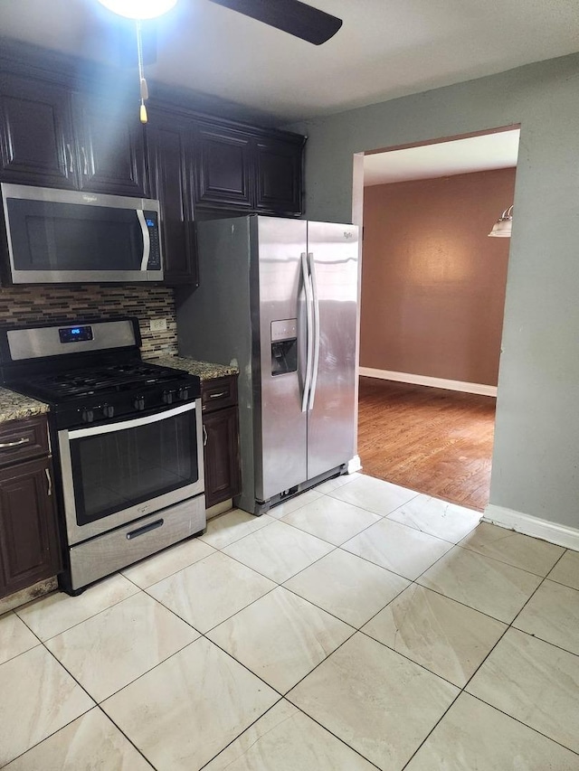 17109 Magnolia Dr, Hazel Crest, IL 60429 - kitchen featuring appliances with stainless steel finishes, light stone counters, tasteful backsplash, and baseboards