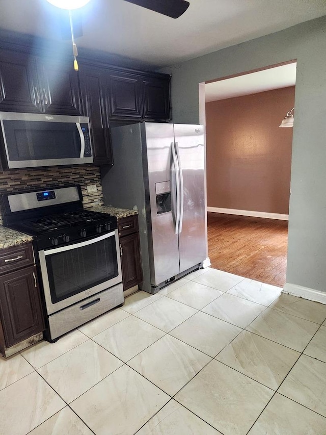 17109 Magnolia Dr, Hazel Crest, IL 60429 - kitchen with stainless steel appliances, light stone countertops, baseboards, and backsplash