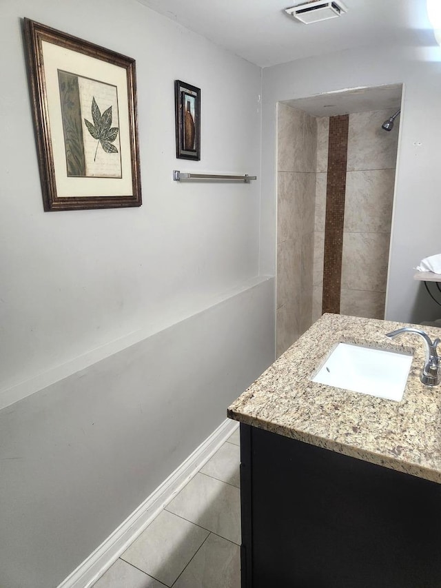 17109 Magnolia Dr, Hazel Crest, IL 60429 - bathroom featuring tile patterned floors, vanity, a tile shower, and baseboards