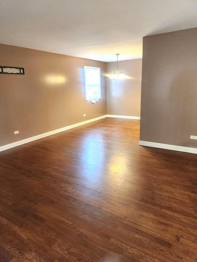 17109 Magnolia Dr, Hazel Crest, IL 60429 - unfurnished room with dark wood finished floors, a chandelier, and baseboards