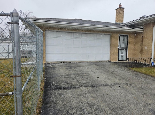 garage with driveway and fence