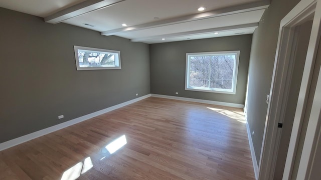 empty room featuring recessed lighting, baseboards, beamed ceiling, visible vents, and light wood-style flooring