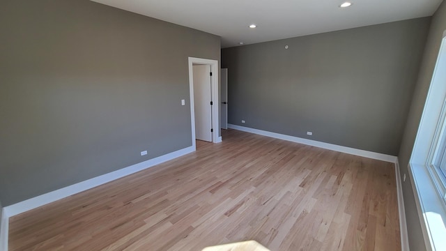 unfurnished room with light wood finished floors, baseboards, and recessed lighting