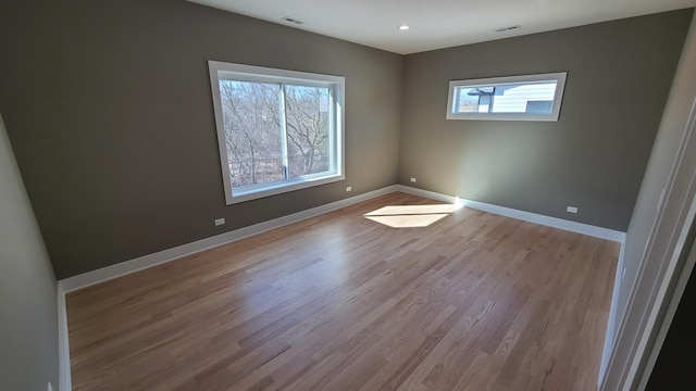 empty room with recessed lighting, visible vents, baseboards, and wood finished floors