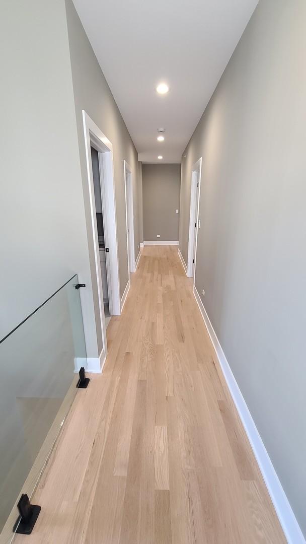 hallway with light wood-style floors and baseboards