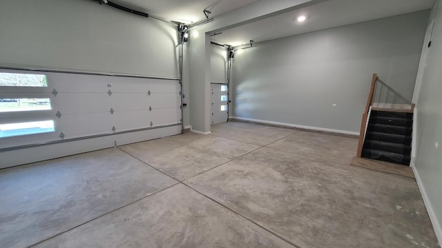 garage featuring baseboards and a baseboard heating unit