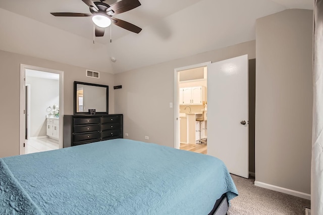 bedroom featuring connected bathroom, vaulted ceiling, a ceiling fan, baseboards, and visible vents