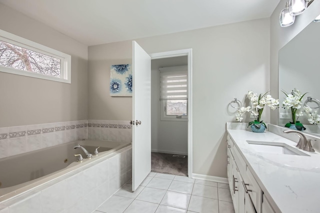 bathroom featuring a jetted tub, tile patterned flooring, vanity, and plenty of natural light
