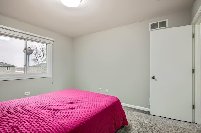 carpeted bedroom with baseboards and visible vents