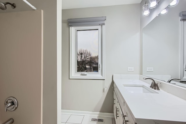 full bath featuring a shower, vanity, tile patterned flooring, baseboards, and visible vents
