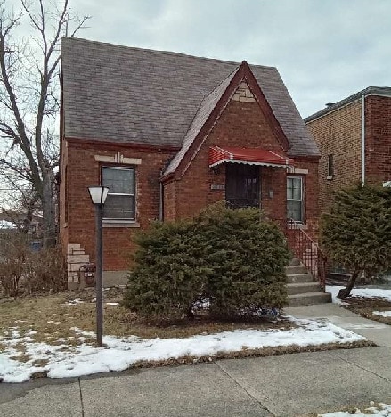 10238 S Rhodes Ave, Chicago, IL 60628 - tudor home featuring brick siding and roof with shingles