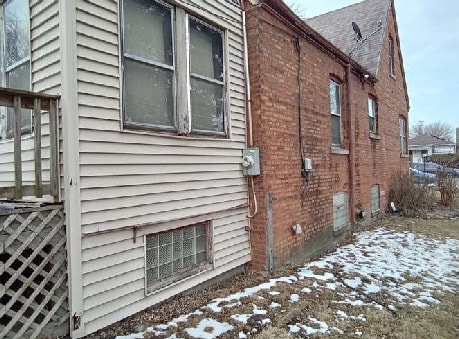 10238 S Rhodes Ave, Chicago, IL 60628 - view of snow covered exterior with brick siding