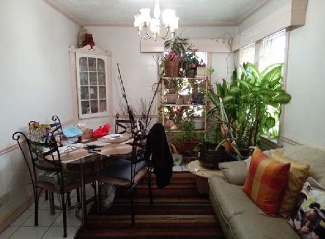 10238 S Rhodes Ave, Chicago, IL 60628 - dining area featuring tile patterned floors and a notable chandelier