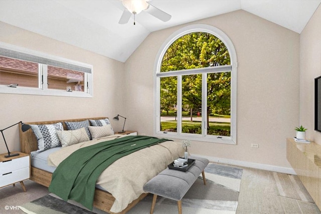 carpeted bedroom with lofted ceiling, baseboards, and ceiling fan