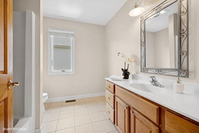 bathroom with vanity, toilet, baseboards, and tile patterned flooring