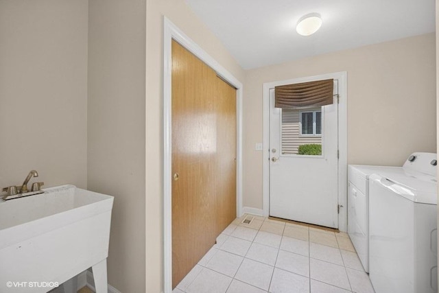 laundry area with separate washer and dryer and light tile patterned flooring