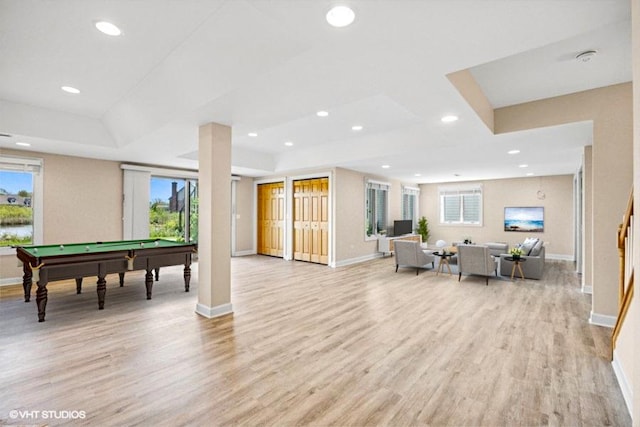 playroom with baseboards, billiards table, light wood-style floors, a raised ceiling, and plenty of natural light