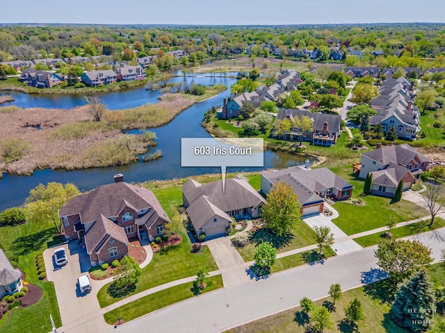 aerial view of residential area featuring a large body of water