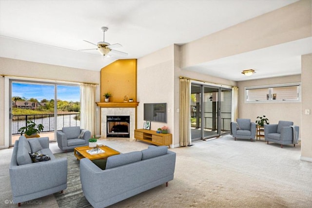carpeted living room with a fireplace and ceiling fan