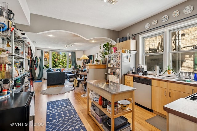 1943 N Whipple St, Chicago, IL 60647 - kitchen featuring appliances with stainless steel finishes, light wood finished floors, light brown cabinetry, and open floor plan