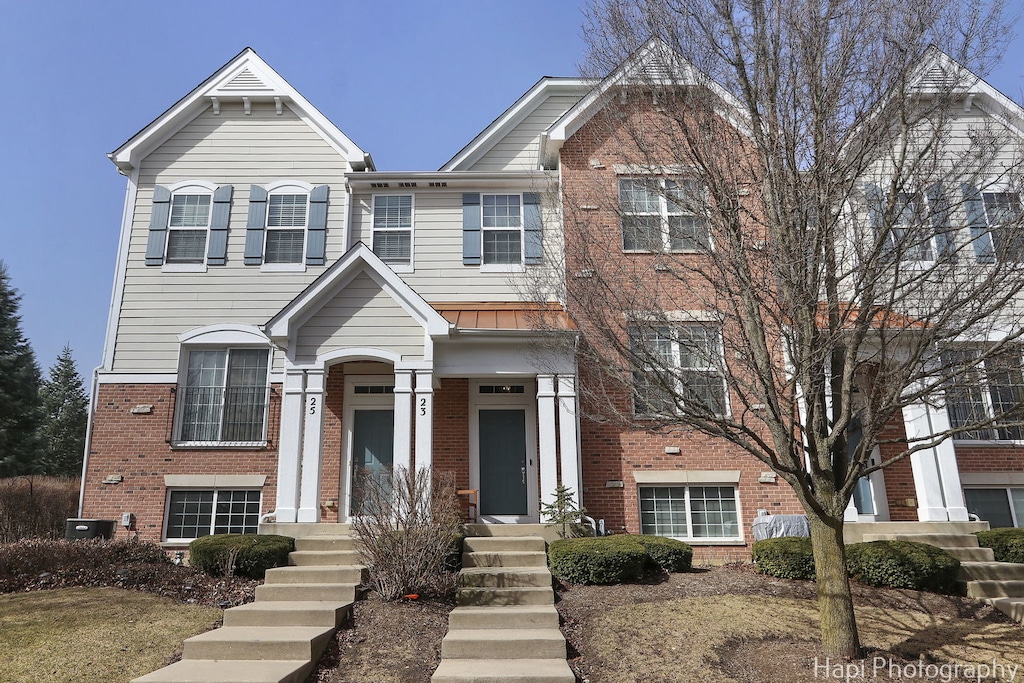 23 Bailey Ln, Lake Zurich, IL 60047 - view of front of home with brick siding and cooling unit