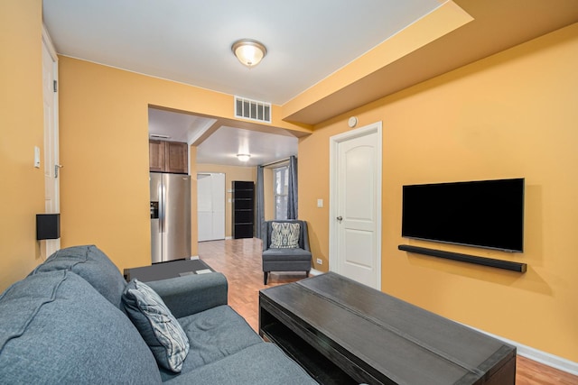 4700 N Monticello Ave Unit 102, Chicago, IL 60625 - living room featuring baseboards, visible vents, and light wood finished floors