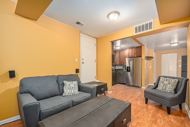 4700 N Monticello Ave Unit 102, Chicago, IL 60625 - living area with baseboards, visible vents, and light wood-style flooring