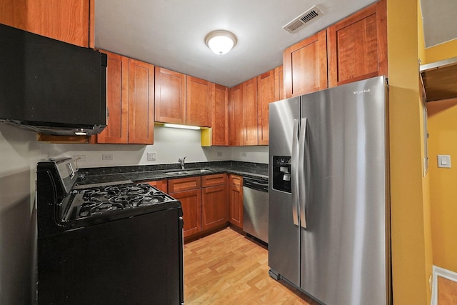 4700 N Monticello Ave Unit 102, Chicago, IL 60625 - kitchen featuring a sink, light wood finished floors, visible vents, appliances with stainless steel finishes, and brown cabinets