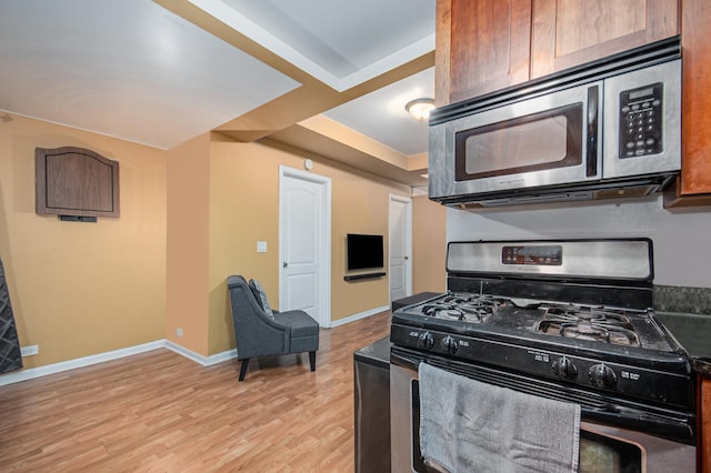 4700 N Monticello Ave Unit 102, Chicago, IL 60625 - kitchen featuring stainless steel appliances, baseboards, and light wood finished floors