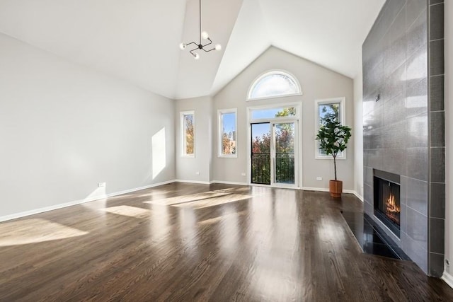 1540 E 65th Pl Unit 3, Chicago, IL 60637 - unfurnished living room featuring high vaulted ceiling, dark wood-type flooring, a chandelier, baseboards, and a fireplace